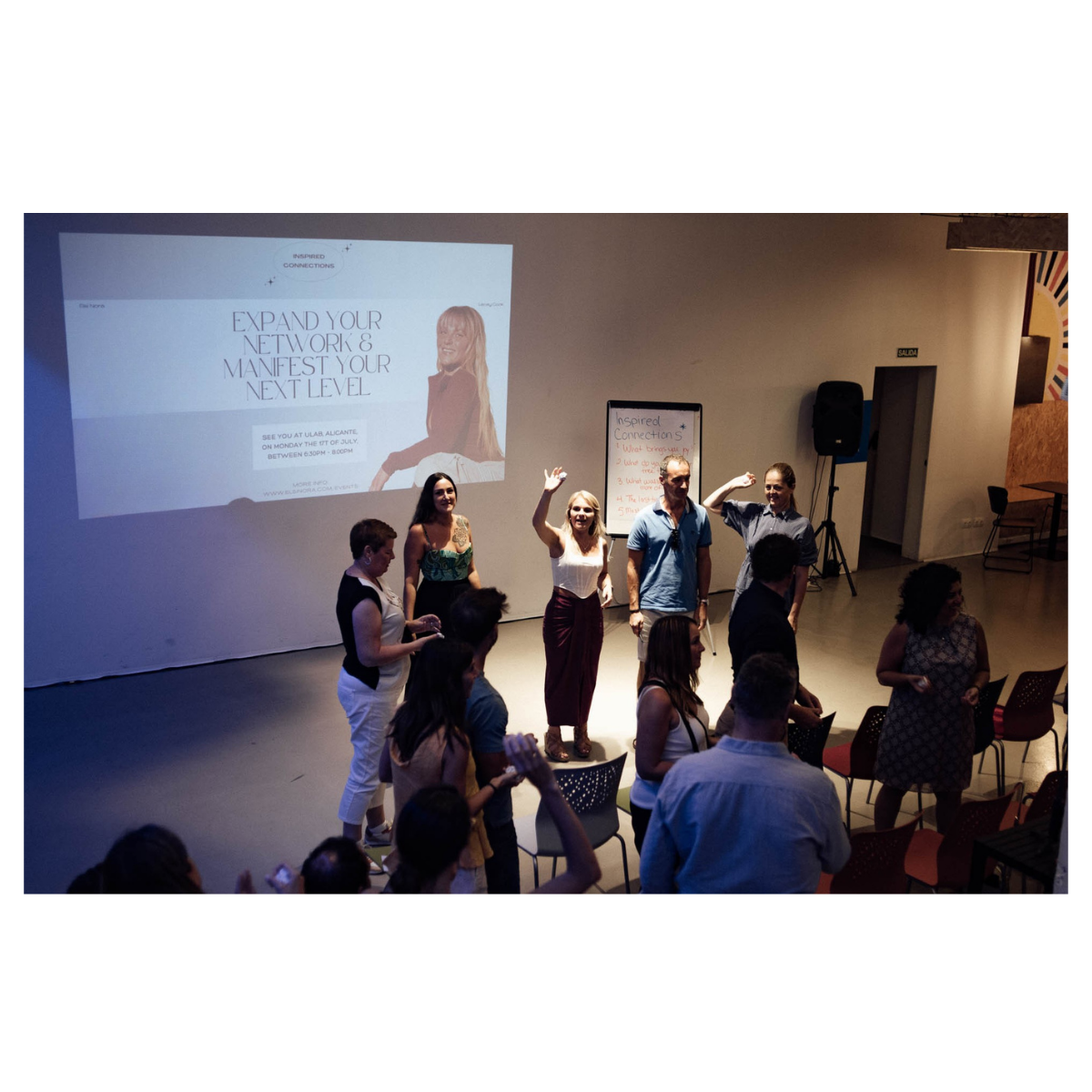 Workshop room with participants and a projector screen
