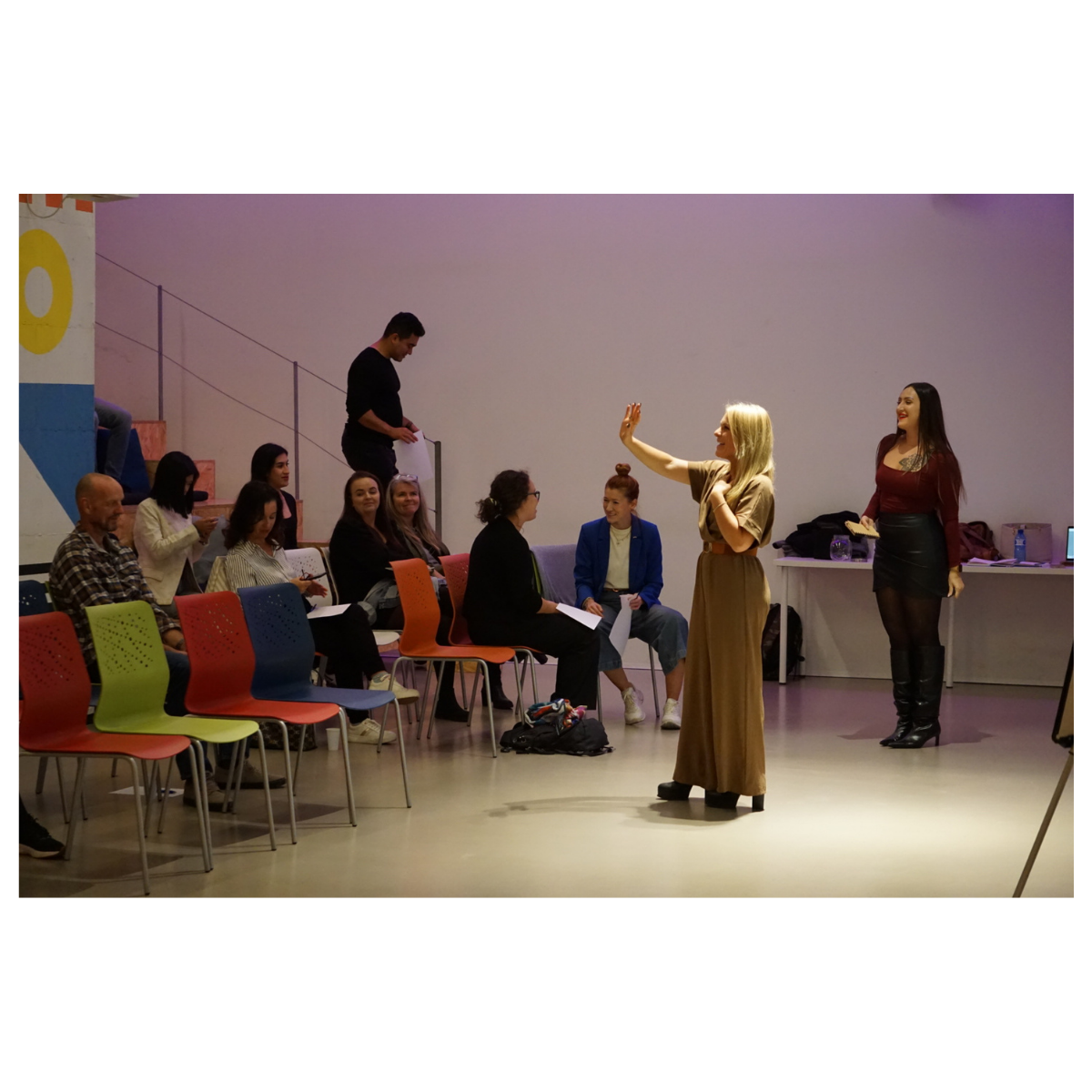 Facilitator leading an interactive workshop for a seated group